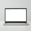 A sleek silver laptop is positioned on a plain white surface. The screen displays a web Royalty Free Stock Photo