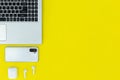 Modern Tech Workspace With Laptop, Smartphone, AirPods And Plant On Bright Yellow Background.Ideal for tech, work, and lifestyle t Royalty Free Stock Photo