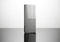 Sleek silver rectangular object standing upright on a reflective surface Royalty Free Stock Photo