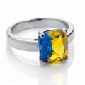 Silver ring with cushion cut blue and yellow gemstone on white background jewelry Royalty Free Stock Photo