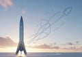 A sleek, silver rocket stands upright on a flat surface at sunrise or Royalty Free Stock Photo