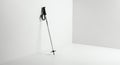 Sleek Silver Ski Pole with Black Handle and Striped Strap Leaning in a Bright White Minimalist Corner Royalty Free Stock Photo
