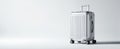 The sleek silver suitcase standing against a minimalist background..AI generated image Royalty Free Stock Photo