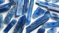 Sleek and slender Kyanite blades exhibiting their sapphire-like blue elegance, arranged gracefully on a white canvas