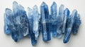 Sleek and slender Kyanite blades exhibiting their sapphire-like blue elegance, arranged gracefully on a white canvas