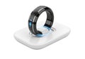 Sleek smart ring on charging base with glowing futuristic interface Royalty Free Stock Photo