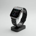 A sleek smartwatch with a square display, featuring a metallic frame and a digital