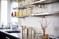 sleek stainless steel kitchen shelves stocked with spice bottles Royalty Free Stock Photo