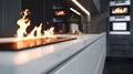 A sleek and stylish kitchen with a linear fireplace built into the sleek white cabinets. The flickering flames add a
