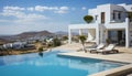 Sleek and stylish modern white house with a refreshing pool, surrounded by majestic mountains