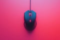 Sleek and stylish wired optical mouse displayed on a vibrant pink background top view perspective Royalty Free Stock Photo