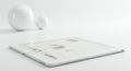A sleek tablet displaying gray-scale graphs and charts rests on a flat white surfac