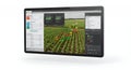 Tablet Displaying Smart Farming Interface with Digital Charts Over Green Fields on White Background for Agricultural Royalty Free Stock Photo