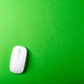 Sleek White Computer Mouse on a Vibrant Green Background Royalty Free Stock Photo