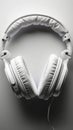 Sleek white headphones arranged neatly on clean white background