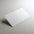 A sleek white notepad or tablet standing upright against a neutral background Royalty Free Stock Photo