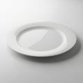 A sleek white plate with a minimalist design resting on a plain surface Royalty Free Stock Photo