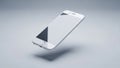 Sleek White Smartphone Floating in Mid- Air Against a Smooth Light Grey Studio Background Royalty Free Stock Photo