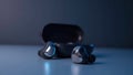 Sleek Wireless Earbuds with Charging Case in Modern Blue Light Royalty Free Stock Photo