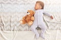 Sleep is a bear necessity of life. High angle shot of a little baby boy sleeping on a bed with a teddy bear.