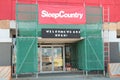 tor, canada - july 31, 2023: sleep country canada welcome we are open sign above store doors glass on canopy. p