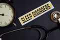 Sleep Disorders on the paper with Healthcare Concept Inspiration. alarm clock, Black stethoscope.