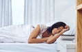 Sleep does the soul good. a young woman sleeping peacefully in her bed at home.