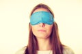 Brunette woman sleeping in blue eye sleep mask Royalty Free Stock Photo