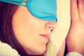 Brunette woman sleeping in blue eye sleep mask Royalty Free Stock Photo