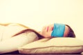 Brunette woman sleeping in blue eye sleep mask Royalty Free Stock Photo