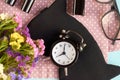 Sleep mask with alarm clock, flowers, mascara and pomade on blue background composition Royalty Free Stock Photo