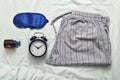 Sleep mask, sleeping pills, alarm clock and pajamas