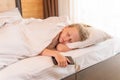 Sleep mobile phone girl beautiful young bed blanket sleeping morning, concept white relax in person for smile positive Royalty Free Stock Photo