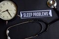 Sleep Problems on the paper with Healthcare Concept Inspiration. alarm clock, Black stethoscope. Royalty Free Stock Photo