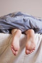 Sleep and relax concept. Beautiful groomed bare feet of cute little child girl Royalty Free Stock Photo