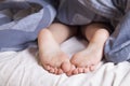 Sleep and relax concept. Beautiful groomed bare feet of cute little child girl. Sleep and rest concept