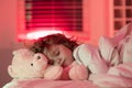 Sleep, sleeping concept. Child sleeping in bed with a toy teddy bear. Cute kid sleeping under blanket. Kid lying on Royalty Free Stock Photo