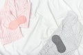 Sleep wear and mask for sleeping on bed. Pink and grey night suits for woman and men