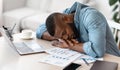 Sleep At Work. Exhausted black freelancer napping at desk at home office Royalty Free Stock Photo