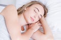 Sleep. Young woman sleeping in bed, portrait of beautiful female resting on comfortable bed with pillows in white bedding