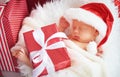 Sleeper newborn baby in Christmas Santa cap Royalty Free Stock Photo