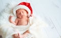 Sleeper newborn baby in Christmas Santa cap Royalty Free Stock Photo