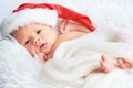 Sleeper newborn baby in Christmas Santa cap Royalty Free Stock Photo