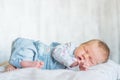 Sleeper newborn baby in a denim jumpsuit Royalty Free Stock Photo