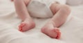 Sleeping, adorable and feet of baby on bed for child care, dreaming and relax in nursery. Family, cute and closeup of Royalty Free Stock Photo