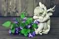 Sleeping angel and violets Royalty Free Stock Photo