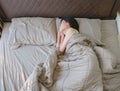 Sleeping Asian woman lying on bed, top view Royalty Free Stock Photo