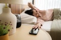 Sleeping asian woman turning off alarm on smartphone while being Waken up in the morning Royalty Free Stock Photo
