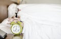 Sleeping asian young male disturbed by alarm clock early morning