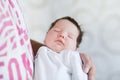 Sleeping baby in the arms of his father. Portrait of a young father holding his newborn baby son at home Royalty Free Stock Photo